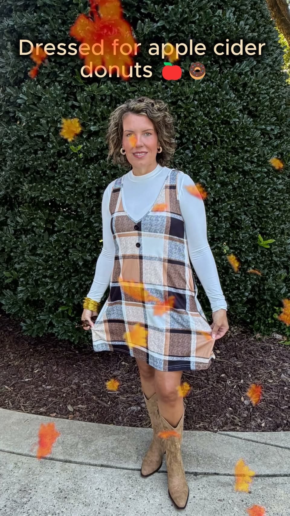 Jessica wearing a plaid fall dress over a white top with distressed Western boots beneath the words Dressed for apple cider donuts