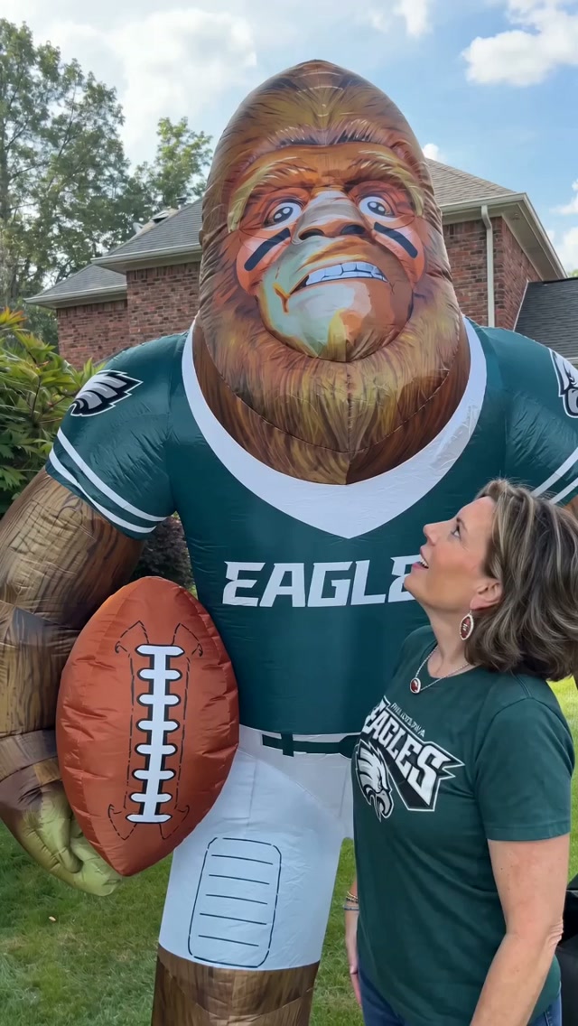 Jessica standing beside an eight-foot football-player inflatable dressed in Philadelphia Eagles colors